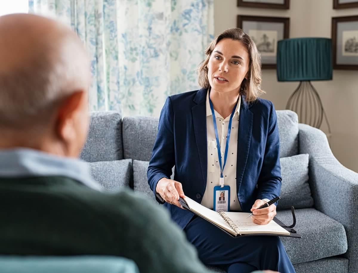 Female Social Worker Speaking with Elderly Client